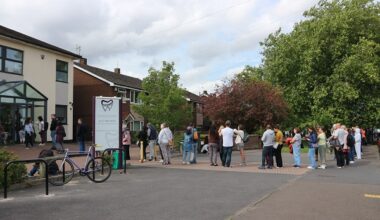 Patients queue outside Lodge Causeway Dental Practice