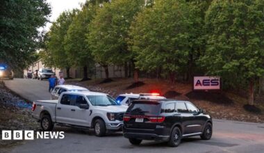 Police cars parked out front of the plant