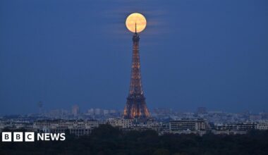 The bright supermoon sitting at the tip of the Eiffel Tower in Paris