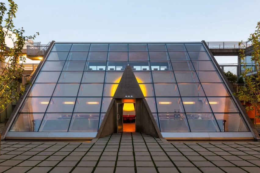Glass building with a triangular concrete portal, within the Waterfall Building complex in Vancouver