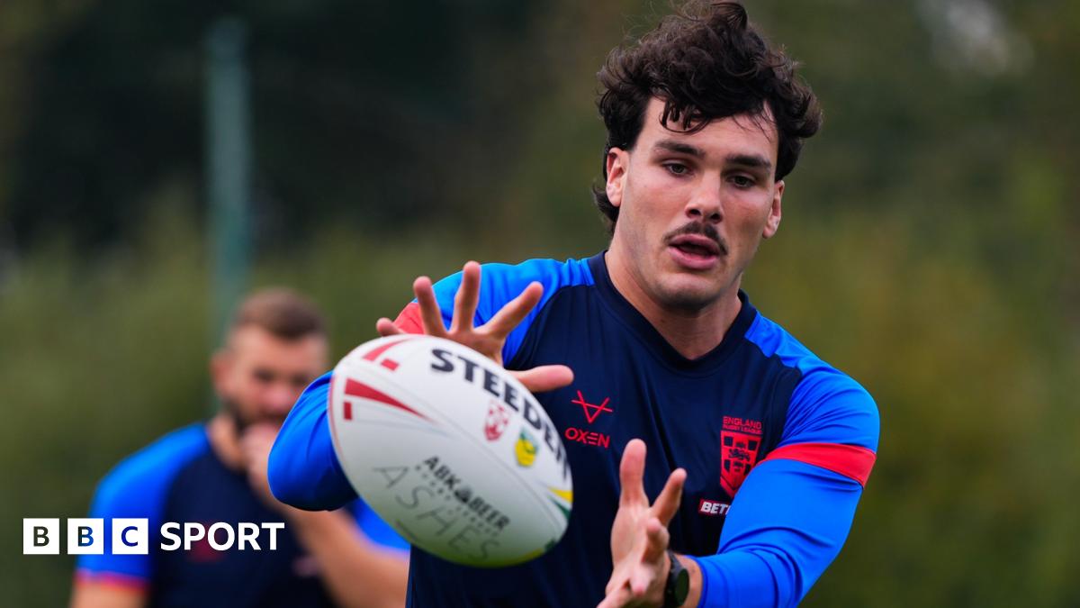 Herbie Farnworth looks off to the right while being filmed with a camera