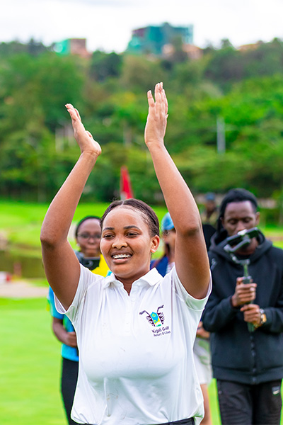 Ishimwe celebrating with her arms up in the air