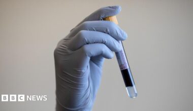 File photo dated 05/06/2020 of a paramedic holding a test tube containing a blood sample.