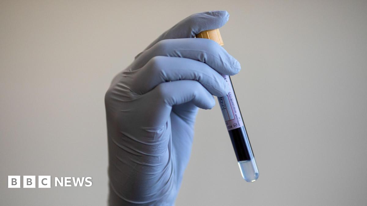 File photo dated 05/06/2020 of a paramedic holding a test tube containing a blood sample.