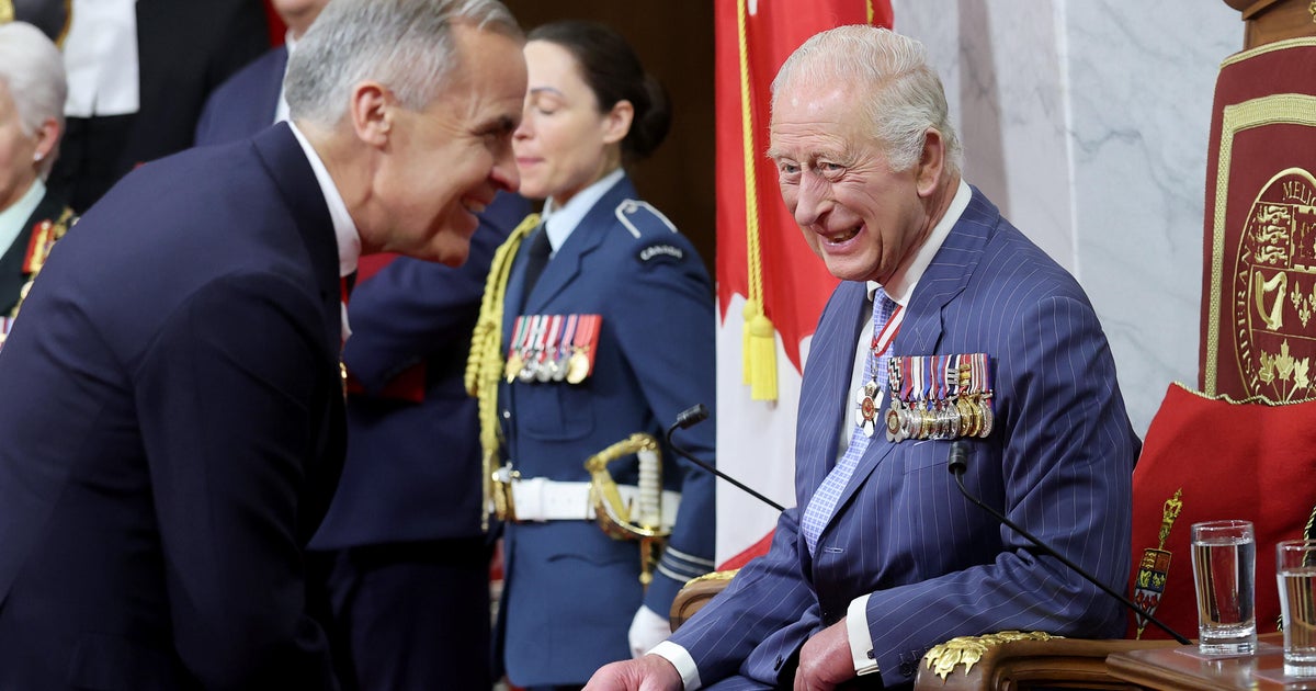 King Charles III smiles at Prime Minister of Canada Mark Carney before opening the 45th Parliament of Canada by delivering the Speech from the Throne during an official visit to Canada on May 27, 2025 in Ottawa, Ontario.