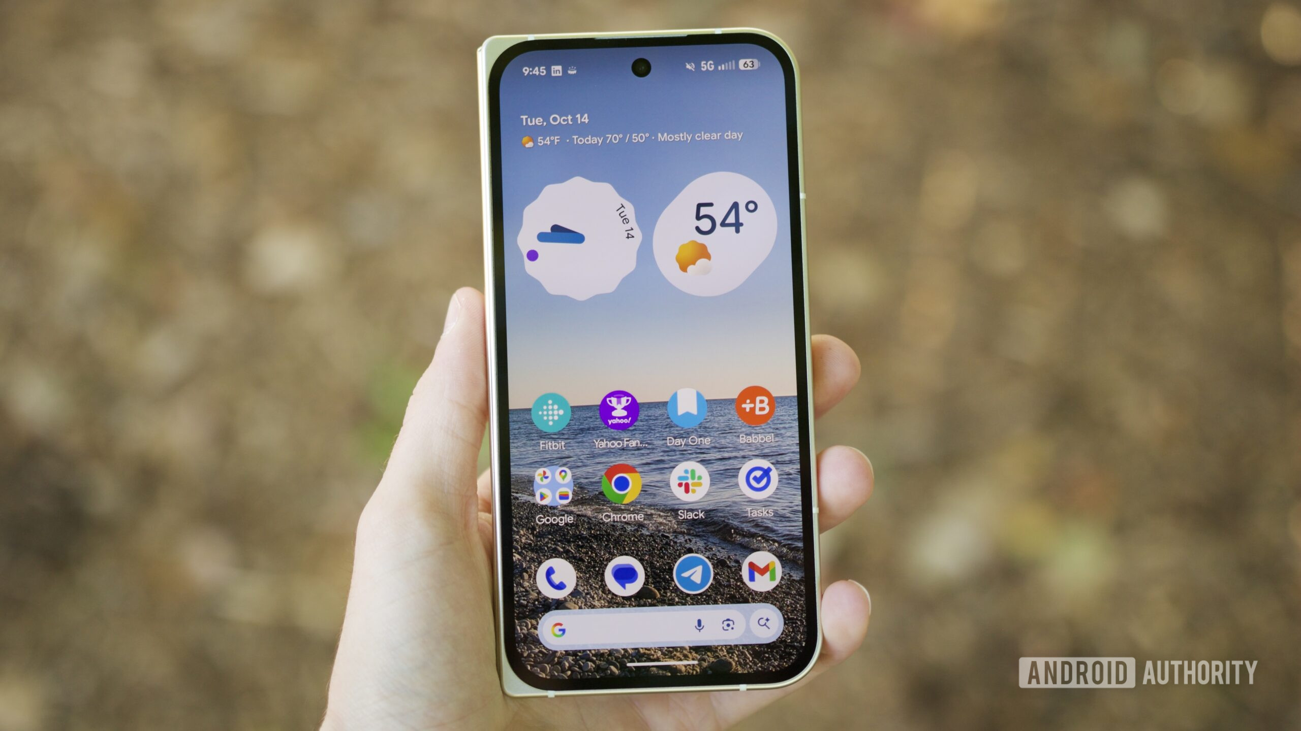 Someone holding the Google Pixel 10 Pro Fold with its cover screen on.