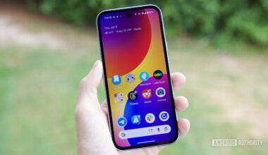 Someone holding a Google Pixel 9a with its screen on.