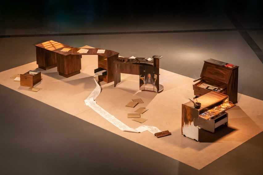 a photograph of an art installation featuring wooden sculptures