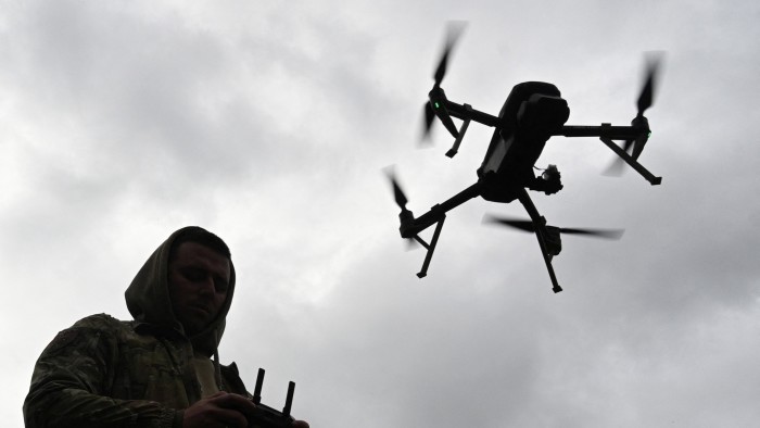 A Ukrainian serviceman operates a drone during a competition that simulates combat conditions