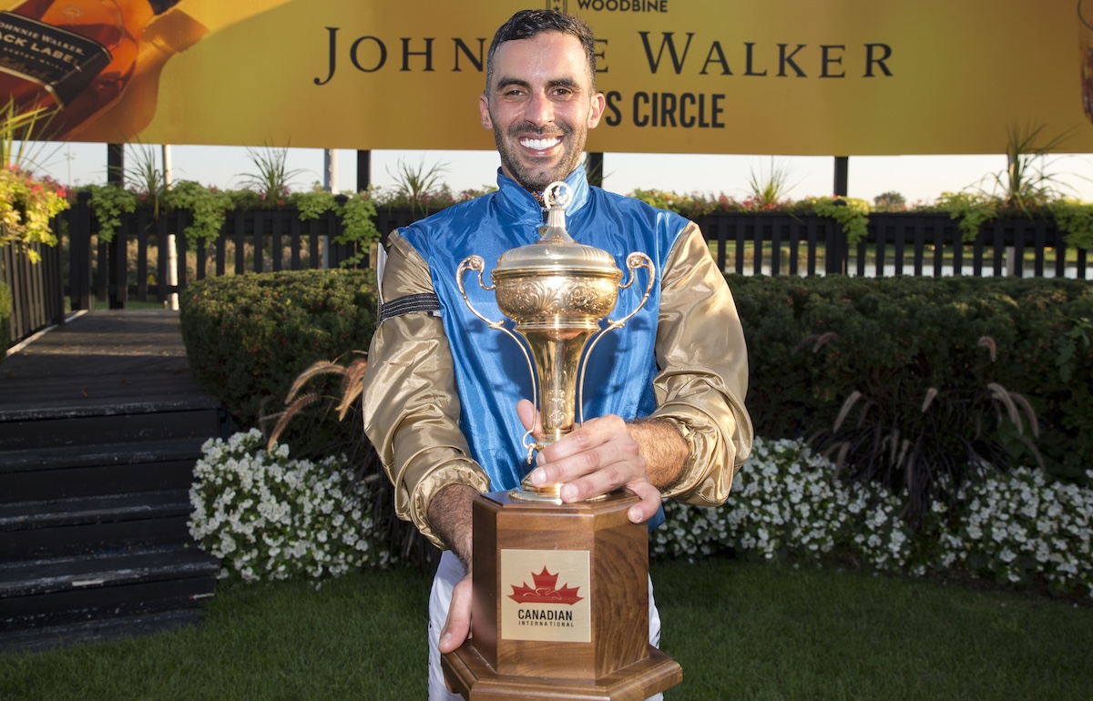 Jockey Faleh Bughenaim with the trophy at Woodbine. Photo: Michael Burns