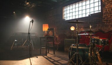 A dimly lit music room with a drum kit and a microphone.