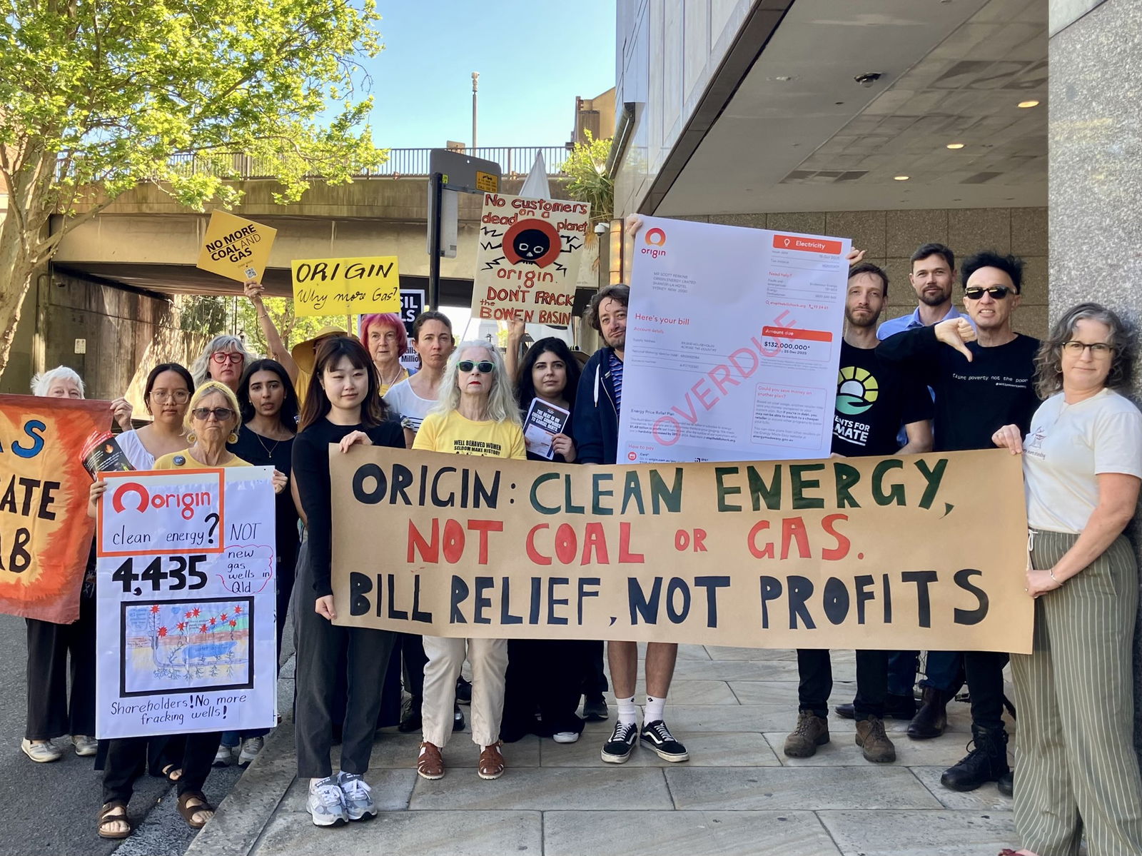 People hold signs protesting oil and gas
