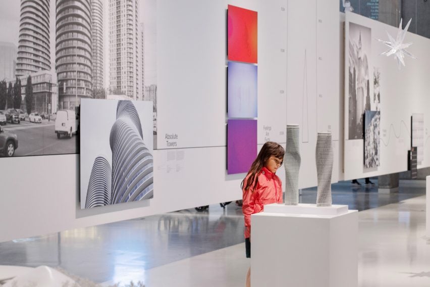 Little girl in red jacket viewing the Absolute Towers model