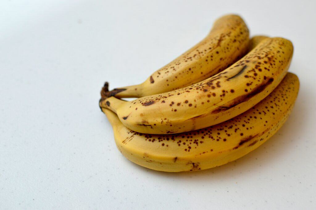 Cavendish bananas on a white surface
