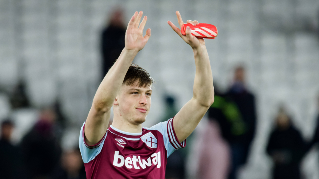 Oliver Scarles claps the fans