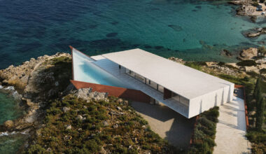 summer residence's sharp geometry emerges from greek seaside slope