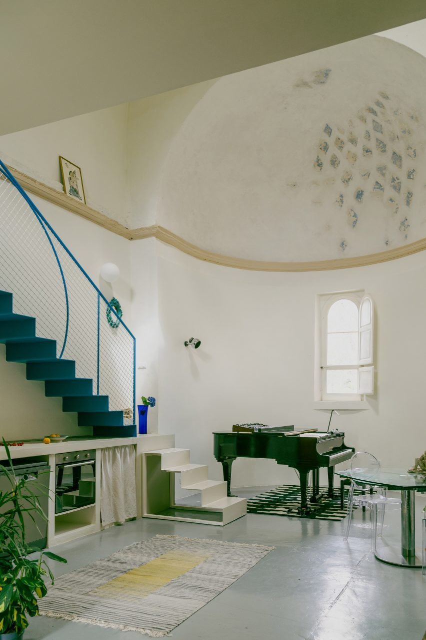 Piano, staircase and apse in Pailunga converted chapel by Atelier Vago
