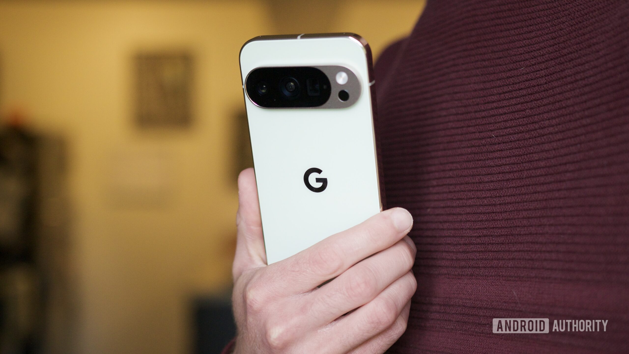 pixel 10 pro holding back of phone hero 2 Someone holding the Pixel 10 Pro, showing the back of the phone.