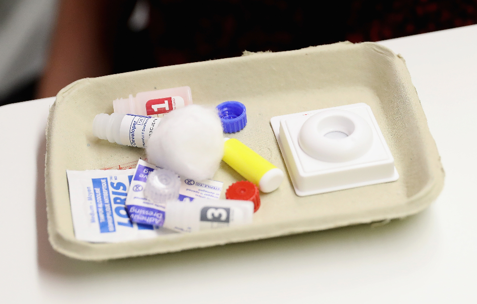 A cardboard tray with a packets and containers of medicine