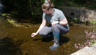 A volunteer testing water for pollution during RiverBlitz 2025