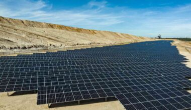 Rows of solar PV modules extend into the background at a former open-cast mine site in Hambach, Germany.