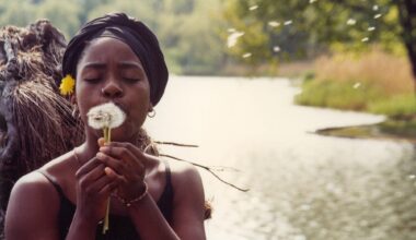 a photo by Jamel Shabazz of a girl blowing a dandelion