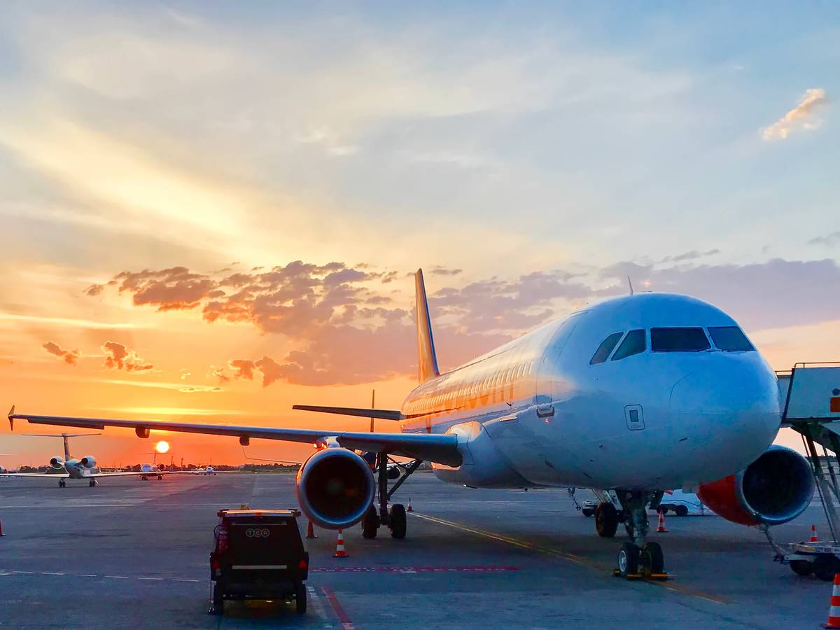 An aircraft on Gatwick airport's runway at sunset