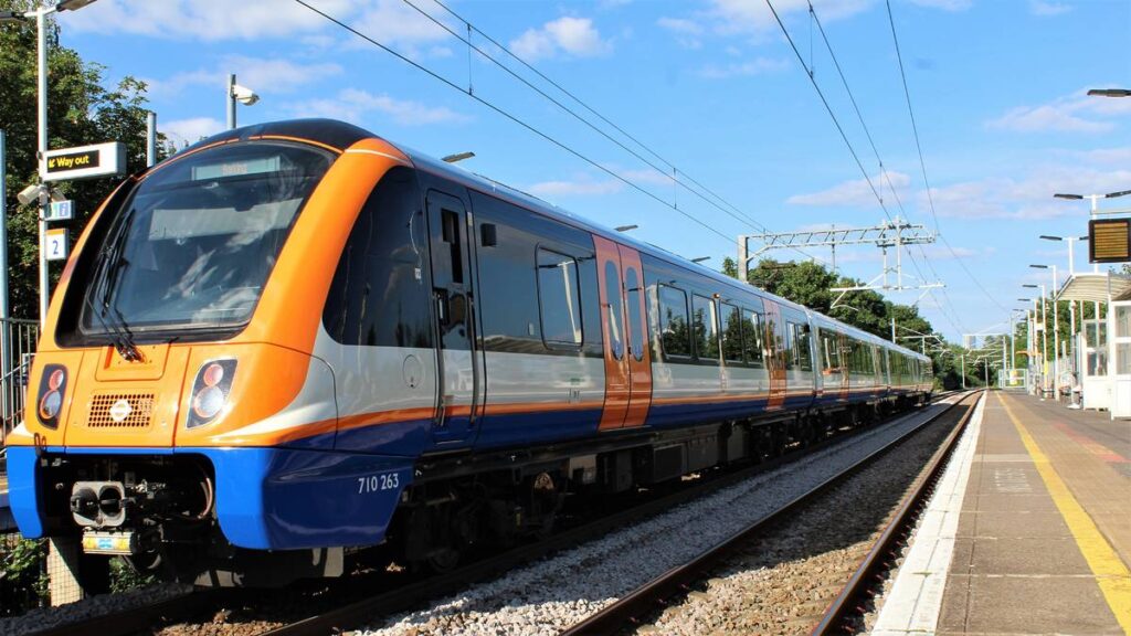 A London Overground train under a blue sky