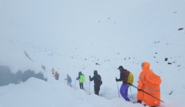 Trekkers are seen leaving their campsite, as unusually heavy snow and rainfall pummelled the Himalayas. Pic: Reuters
