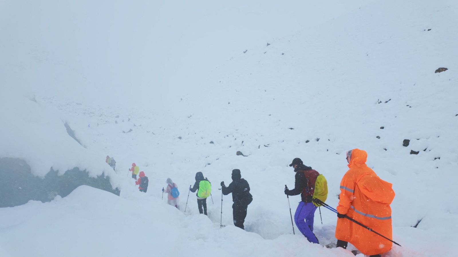 Trekkers are seen leaving their campsite, as unusually heavy snow and rainfall pummelled the Himalayas. Pic: Reuters