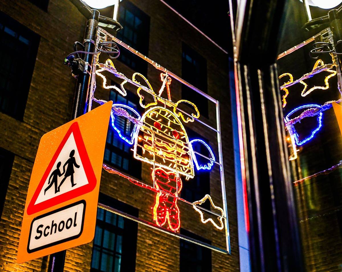 a quirky christmas light design of a christmas pineapple hanging over soho