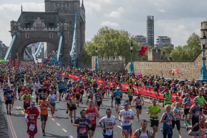runners crossing tower bridge during the london marathon