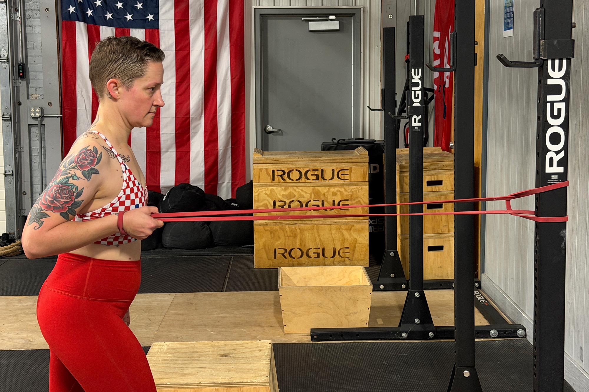 A woman doing standing rows with a band