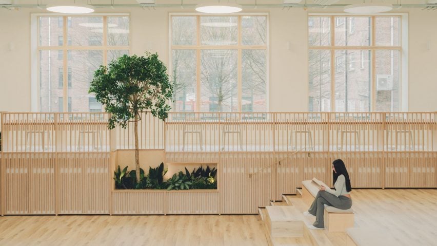 Person reading on steps of retrofitted classroom