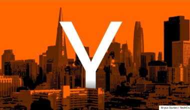 Large white "Y" overlaid on an orange-tinted skyline of San Francisco