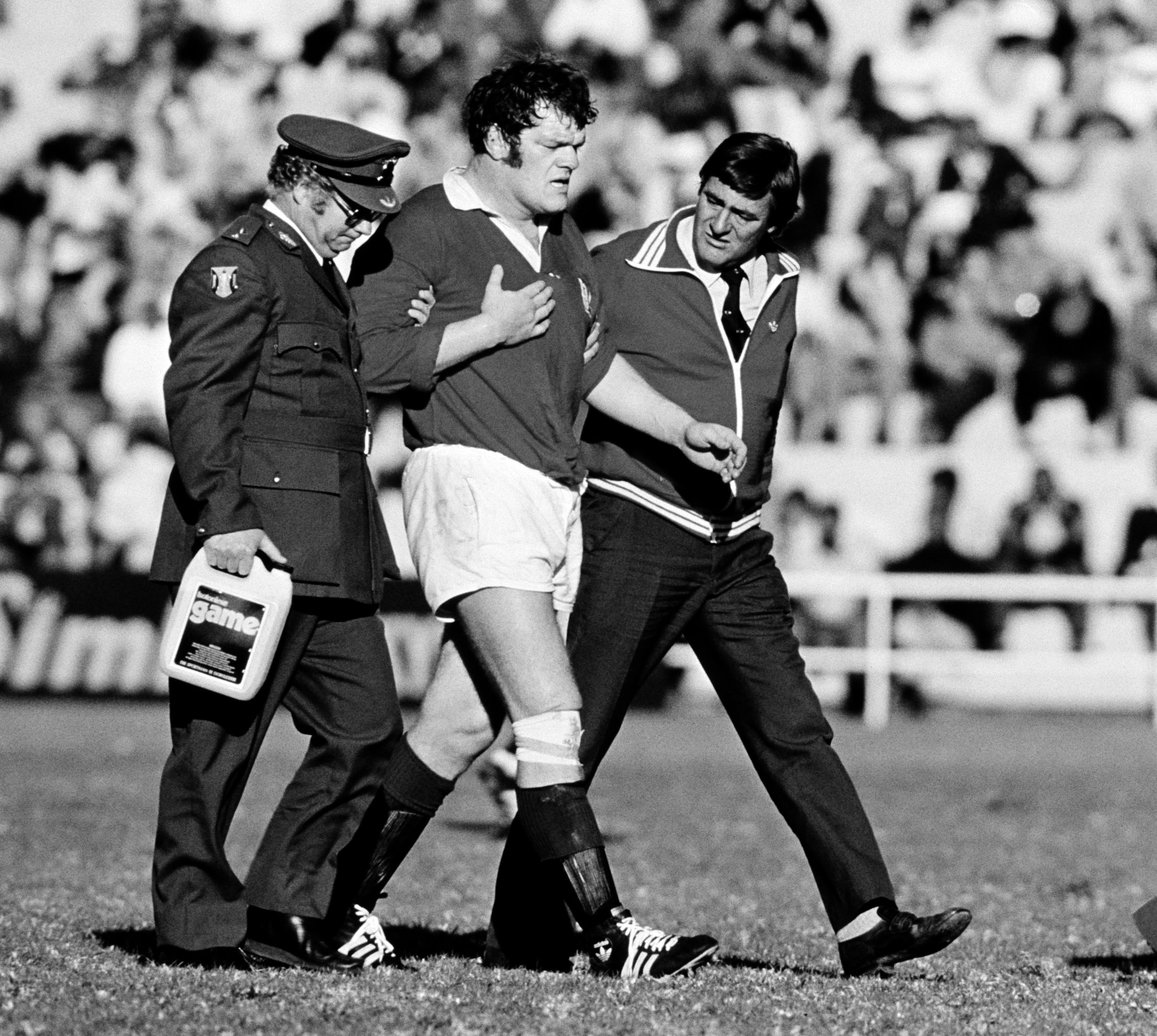 British Lions' Fran Cotton led off the field with a heart condition.