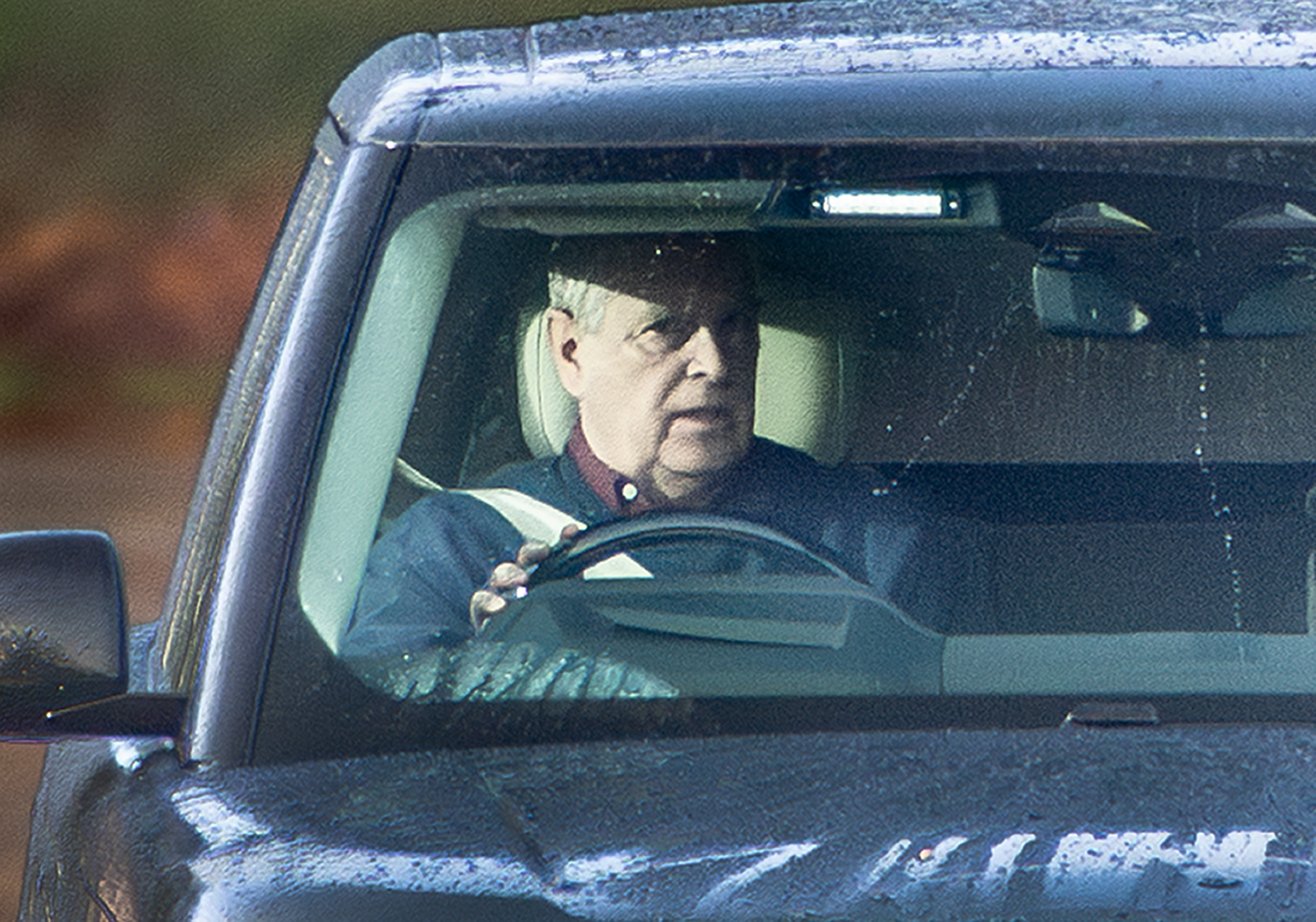 Andrew Mountbatten-Windsor driving a dark car.