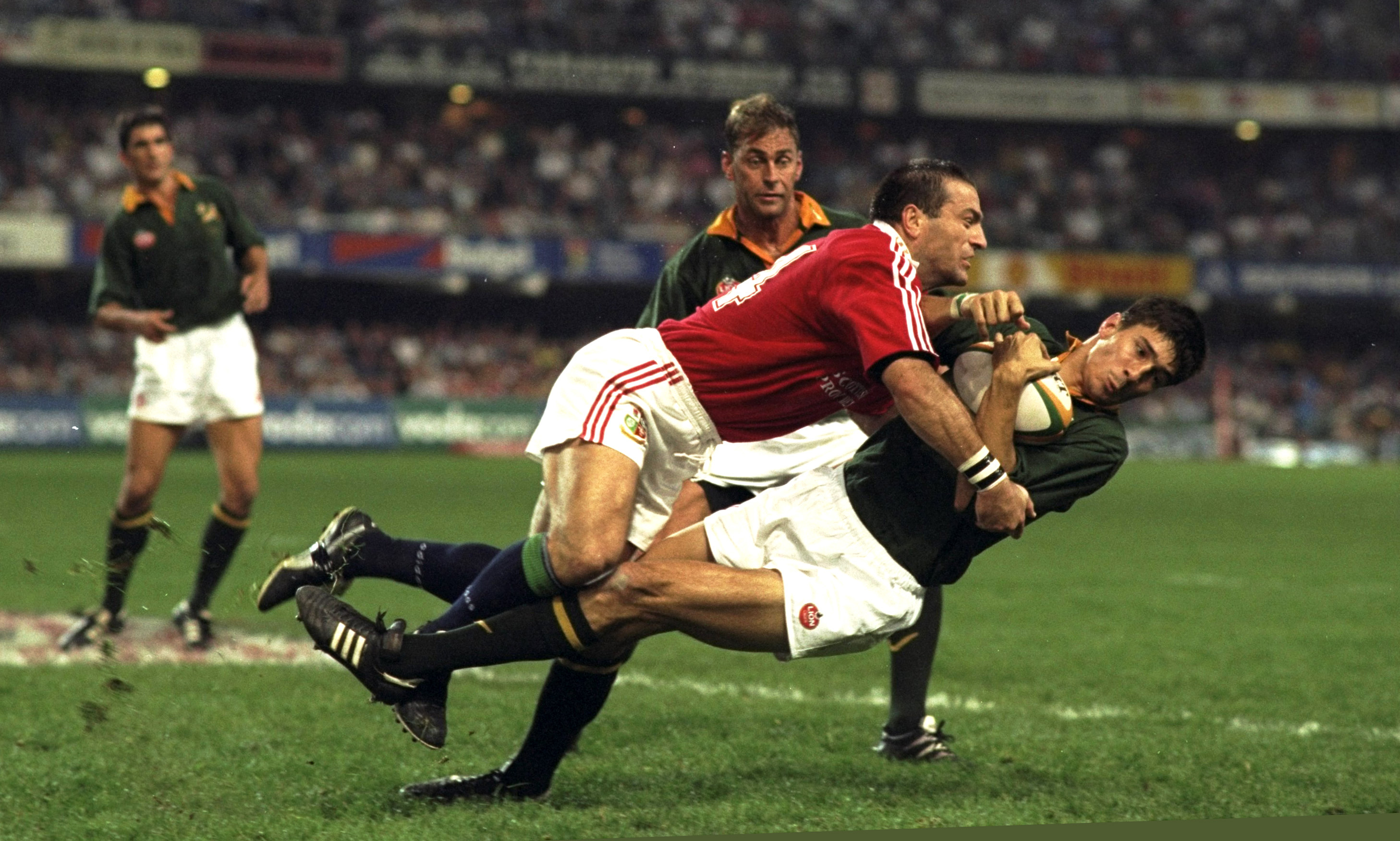 John Bentley of the British Lions tackling Pieter Rossouw of South Africa during a rugby match.