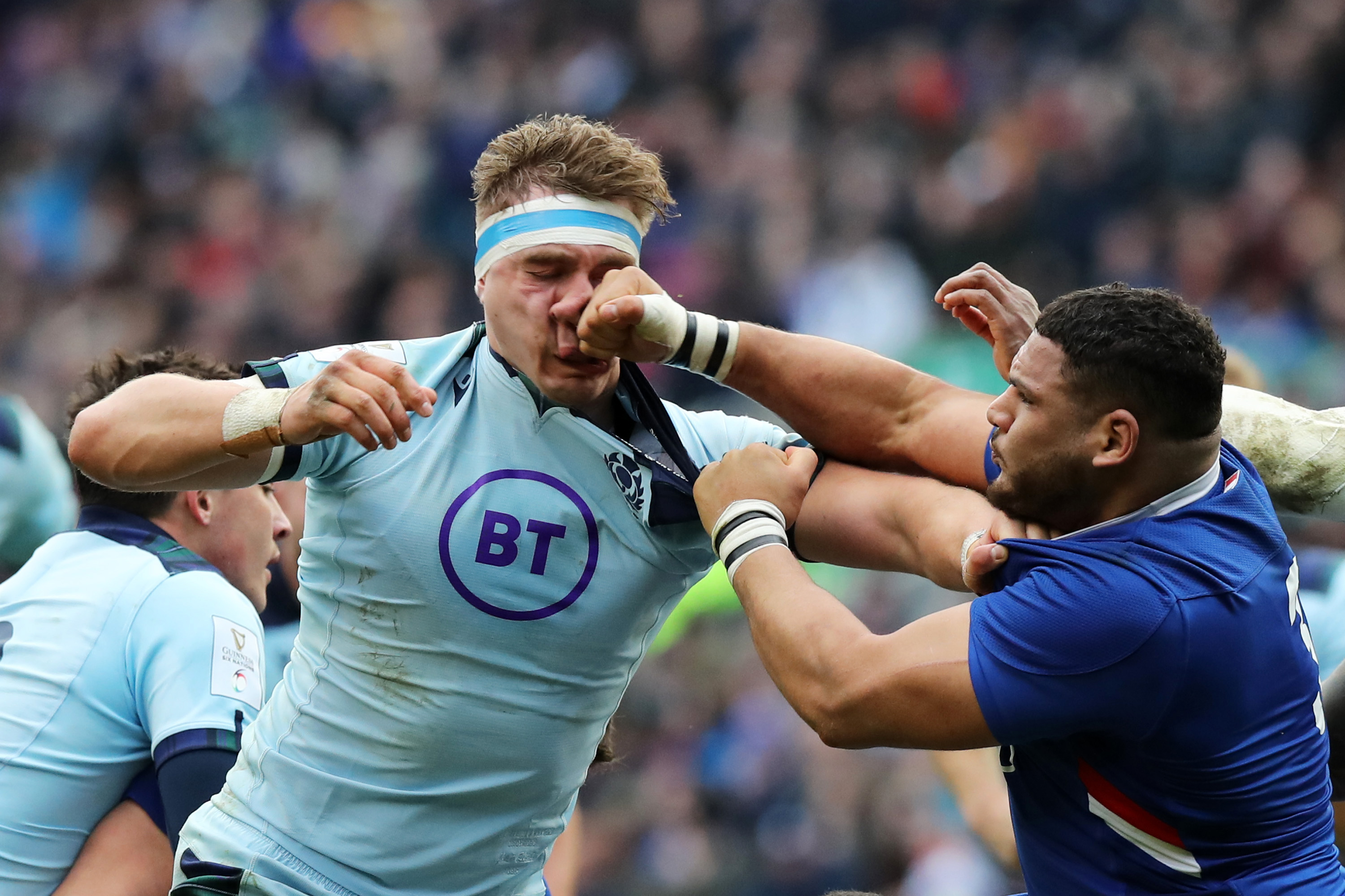 Mohammed Haouas of France punches Jamie Ritchie of Scotland during a rugby match.