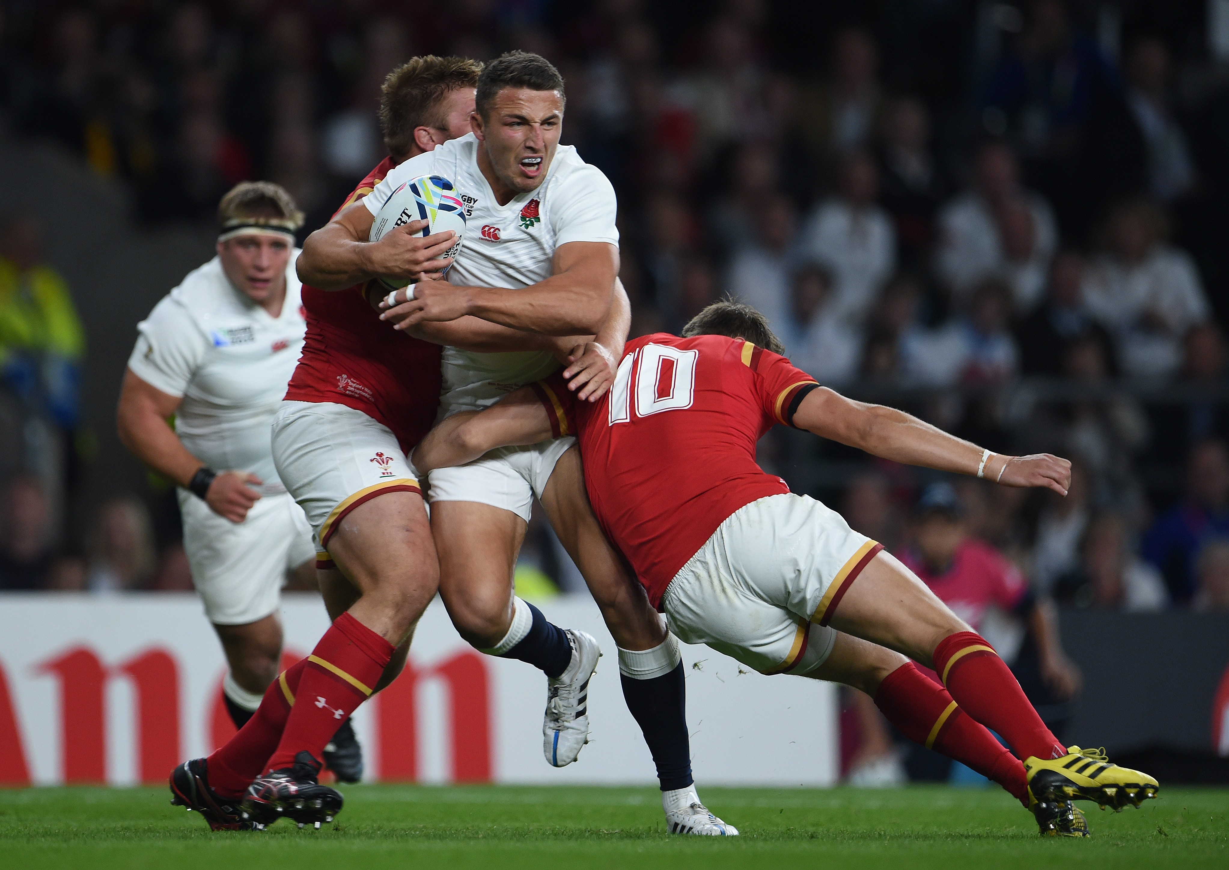 Sam Burgess of England being tackled by Tomas Francis and Dan Biggar of Wales during a Rugby World Cup 2015 match.