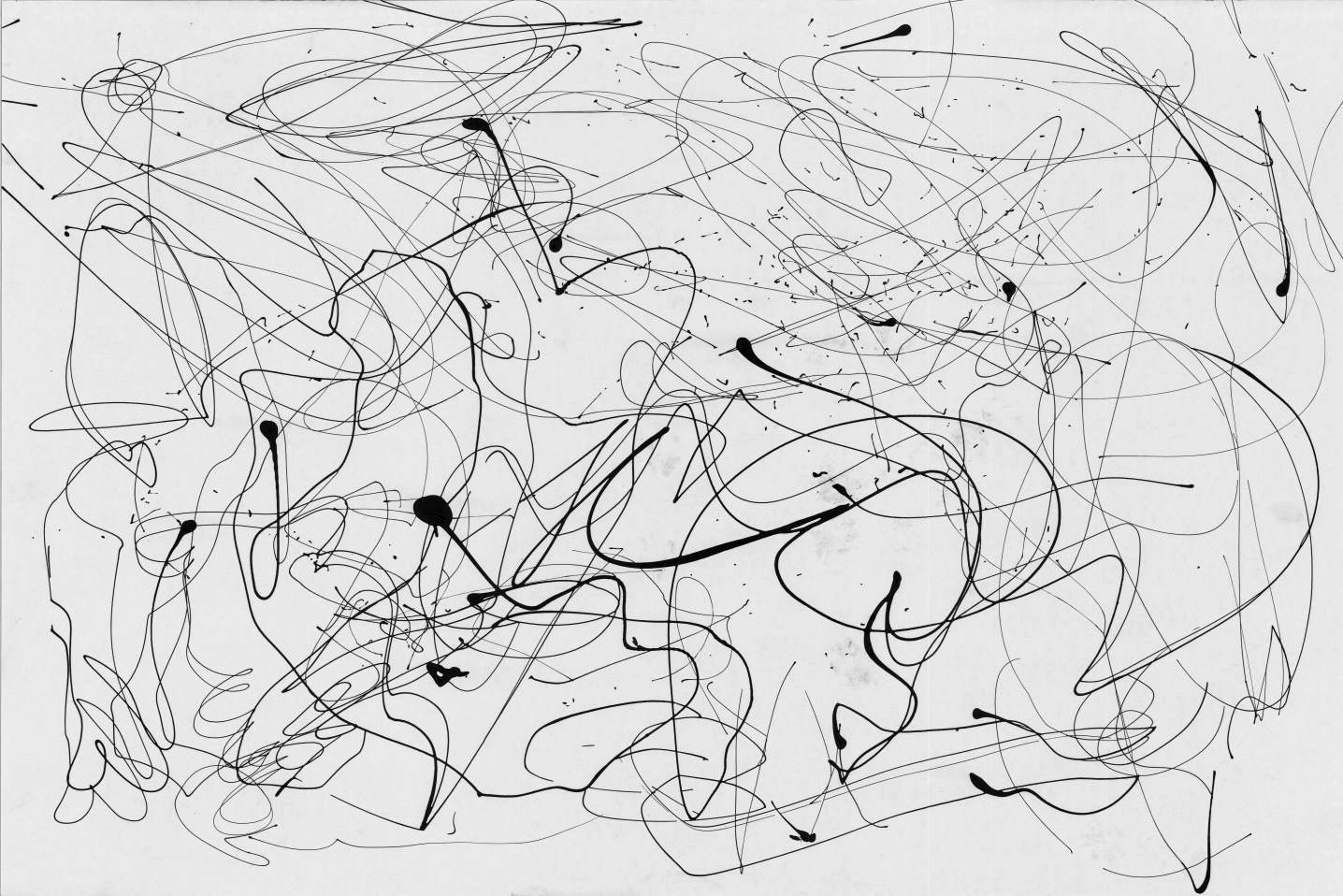 Black paint splattered and dribbled on a white surface, resembling a Jackson Pollock pour-painting.