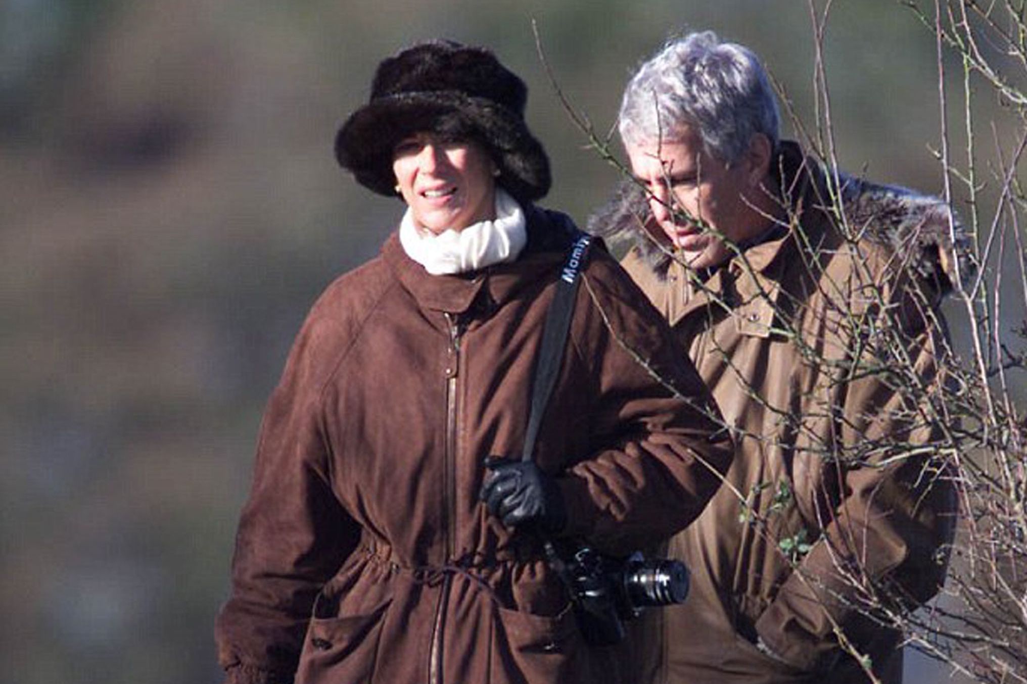 Ghislaine Maxwell and Jeffrey Epstein walking outdoors during a pheasant shoot.