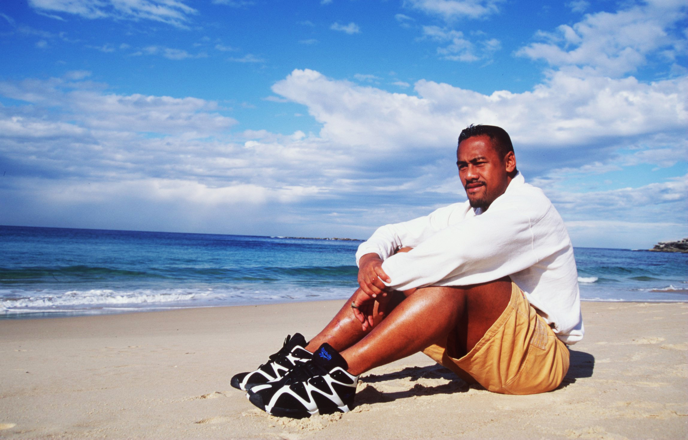 Jonah Lomu, the New Zealand All Blacks winger, relaxes on a beach in Australia.