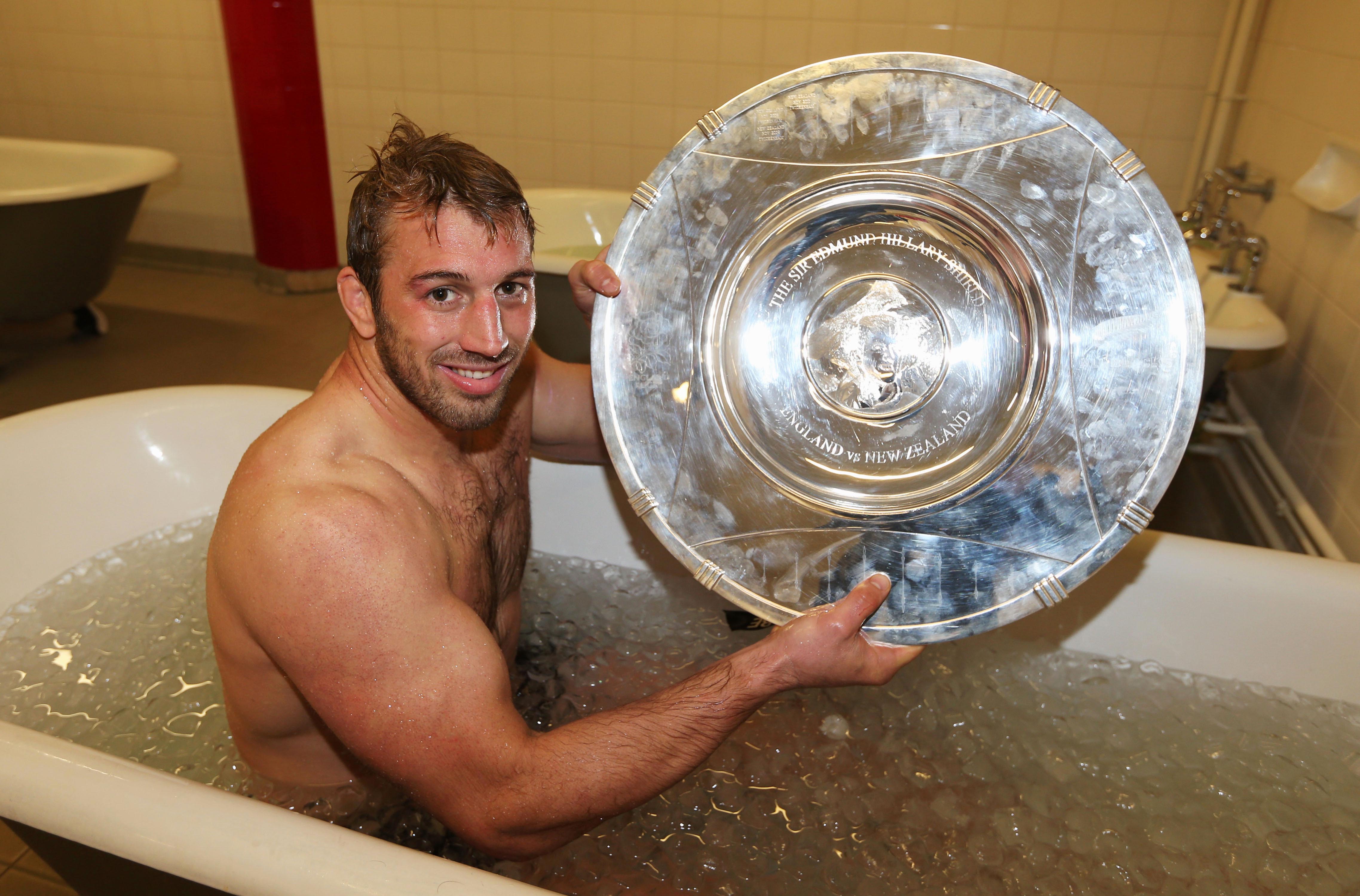 England Rugby Captain Chris Robshaw in an ice bath, holding the Sir Edmund Hillary Shield.
