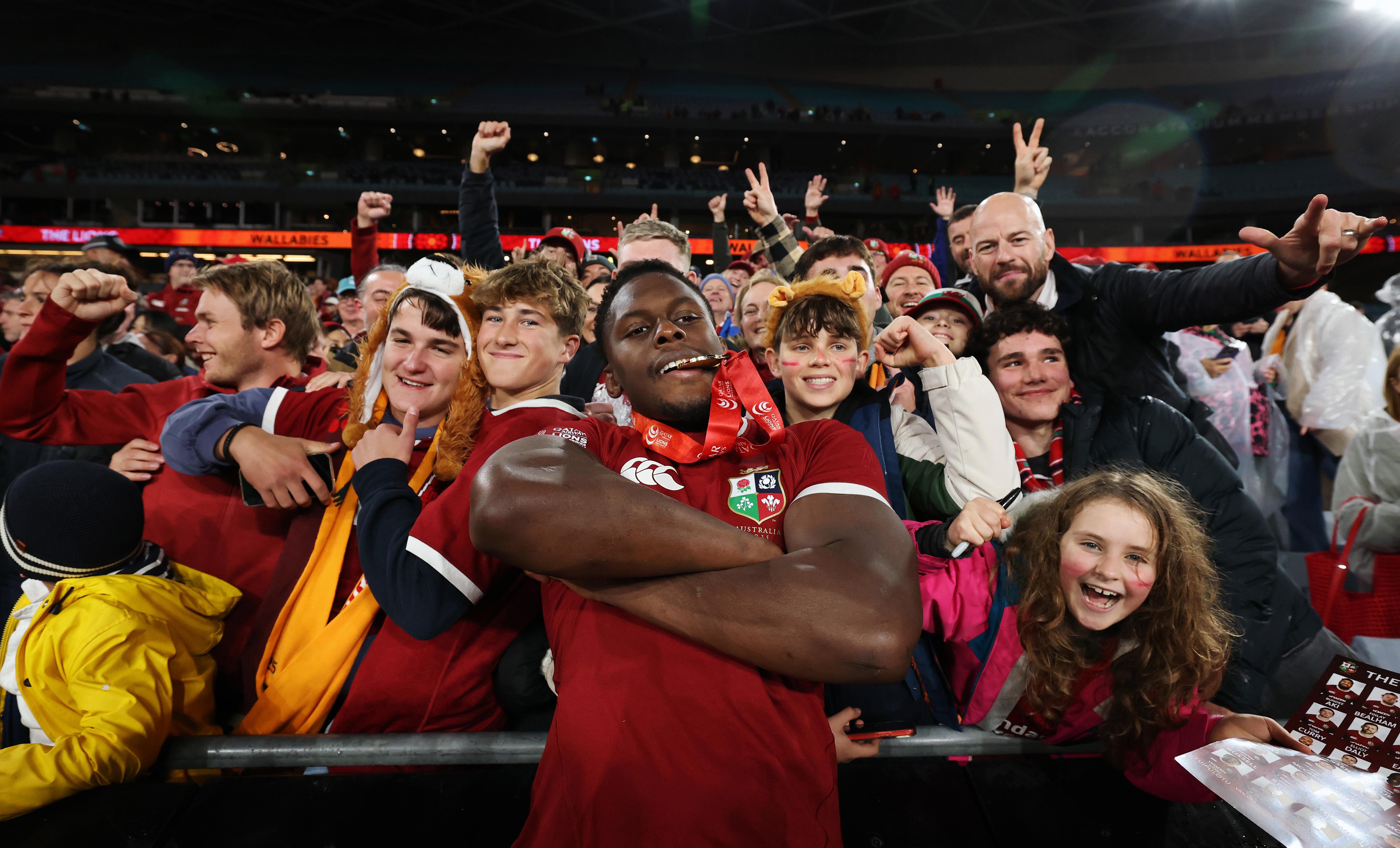 Maro Itoje of the British & Irish Lions celebrates their series victory with fans.