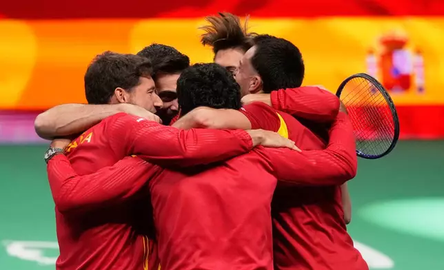 Spain's Marcel Granollers and Pedro Martinez celebrate with their teammates after winning against Germany's Kevin Krawietz and Tim Puetz during a Davis Cup double semifinal tennis match between Spain and Germany, in Bologna, Italy, Saturday, Nov. 22, 2025. (AP Photo/Luca Bruno)