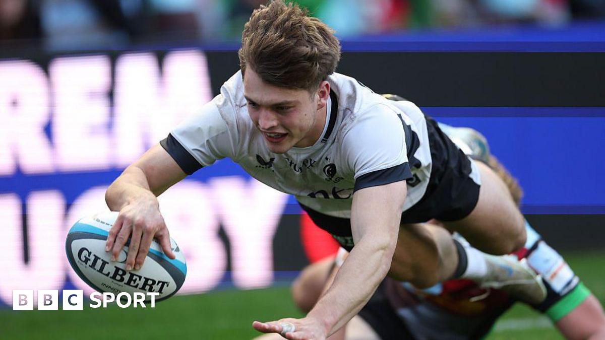 Jack Bracken dives over the line with his arm outstretched holding the ball to score a try for Saracens