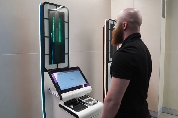 A person uses a EES kiosk during the demonstration