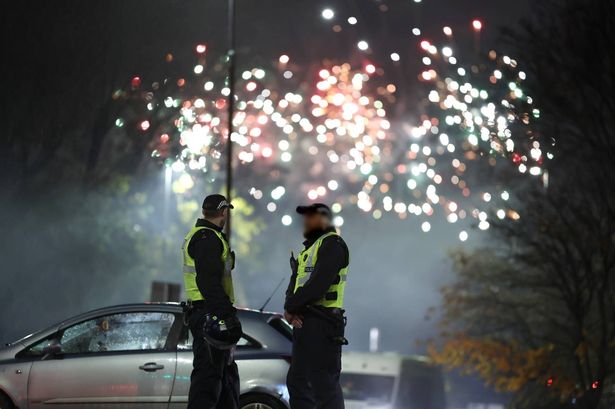 The generic image shows police monitoring a fireworks display