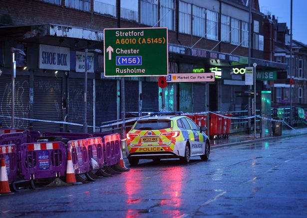 Police at the scene of a double stabbing in Longsight